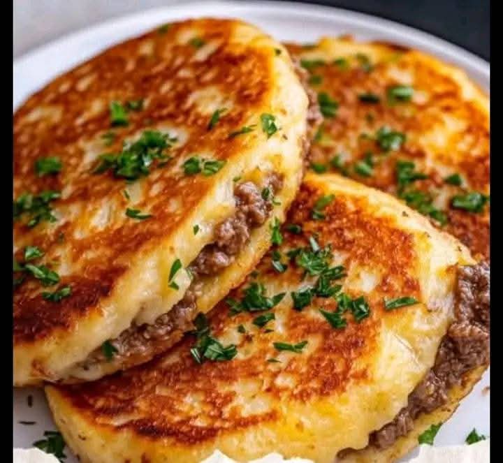 Golden brown mashed potato pancakes with meat filling, served hot with a crispy crust and juicy beef inside – a comforting and easy homemade meal.